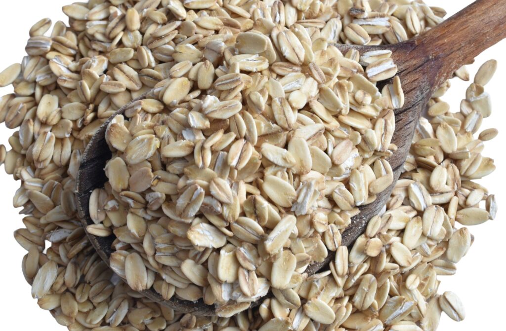 Oatmeal lies in a wooden spoon.